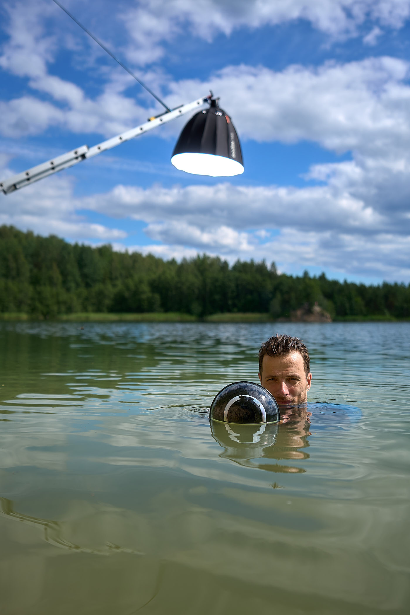A behind-the-scenes photo of how Volodya Voronin captured the BMX in water shot using a ladder, a rope, and a flash