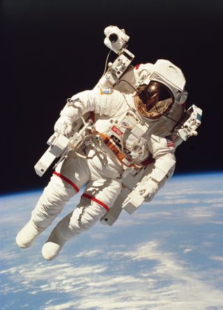 Astronaut Bruce McCandless on space walk with an adapted Nikon D3 on his shoulder
