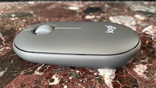 The Logitech Pebble Mouse 2 M350S mouse from the side.
