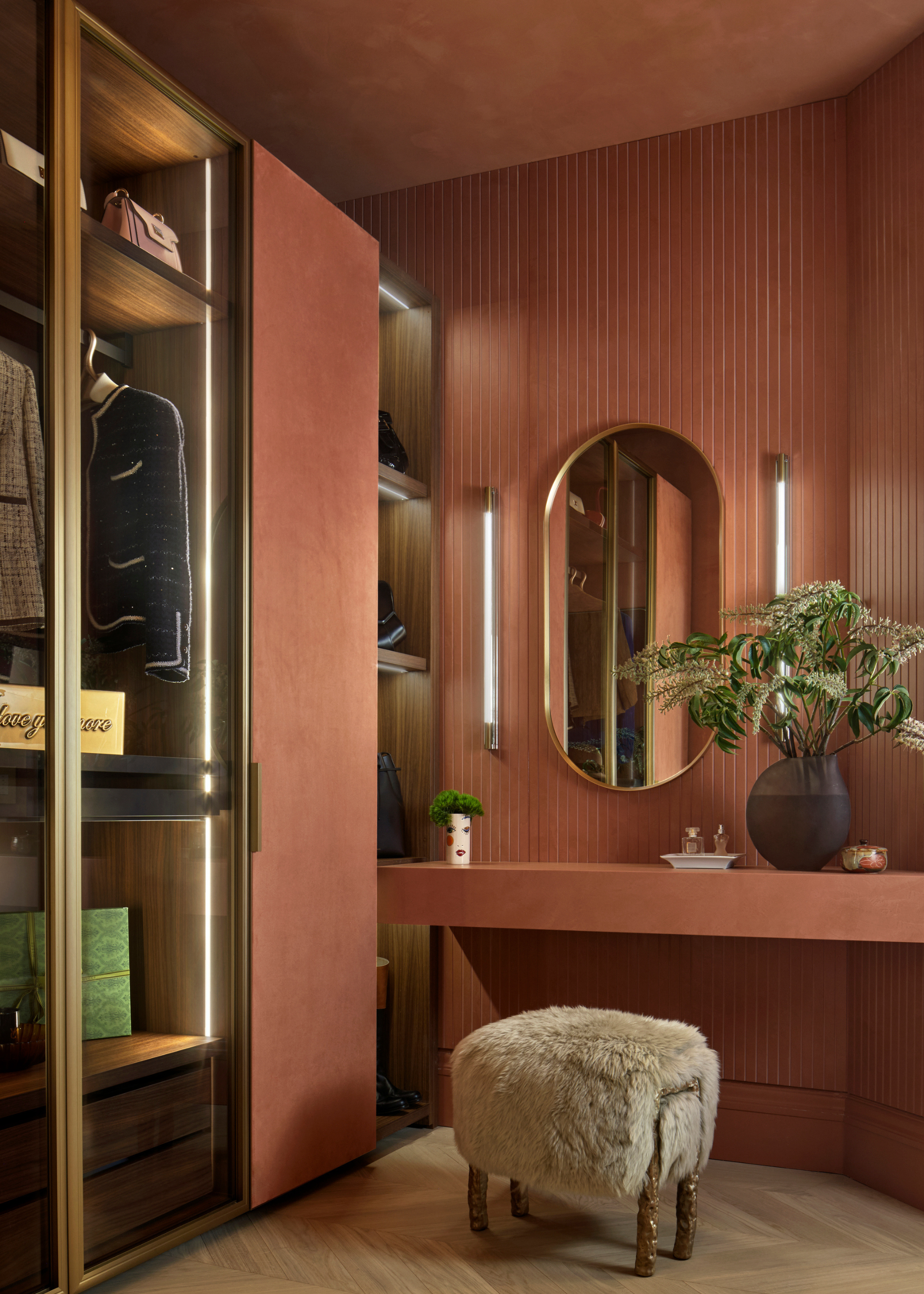 A dusty pink wardrobe with a vanity