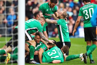 Lincoln City players celebrate after Sean Raggett's winning goal against Burnley in the FA Cup, 2017