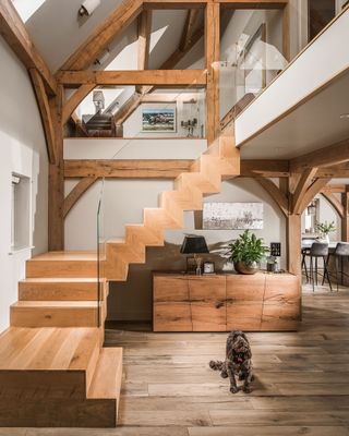 double-height hallway in oak framed home with wooden staircase
