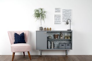 upcycling project of a painted and wallpapered grey sideboard