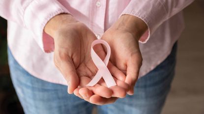 photo of hands holding pink ribbon
