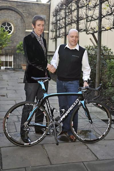 It's a deal! Bradley Wiggins shakes hands with Team Sky manager David Brailsford.