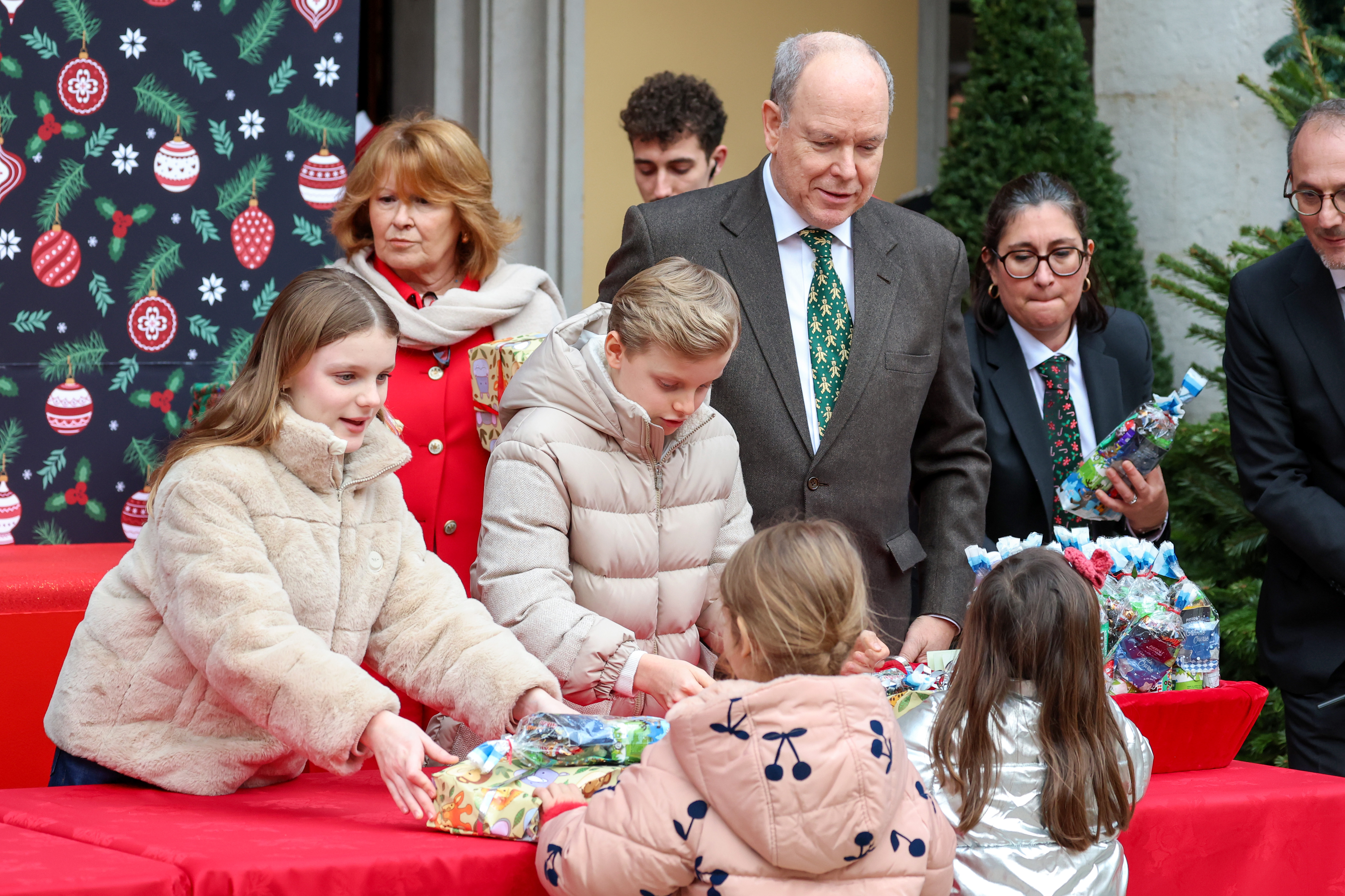 Princess Gabriella and Prince Jacques handing out presents to kids with Prince Albert