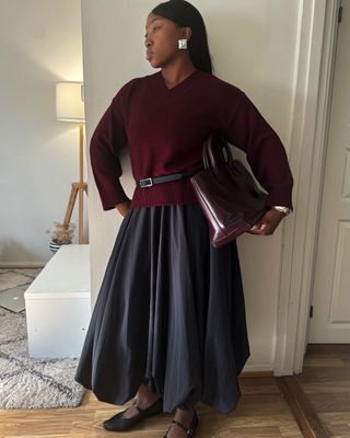 Colours That Go With Burgundy:  @nennaechem wears a burgundy knit and bag with a navy skirt