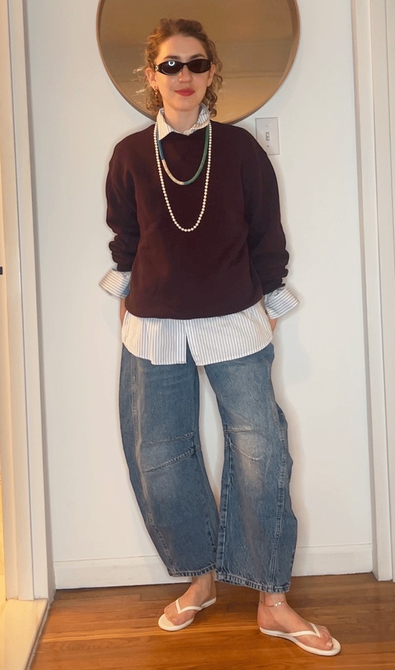 Elizabeth Cardinal Tamkin wearing a brown sweatshirt and a white button down, and a brown sweatshirt and jeans