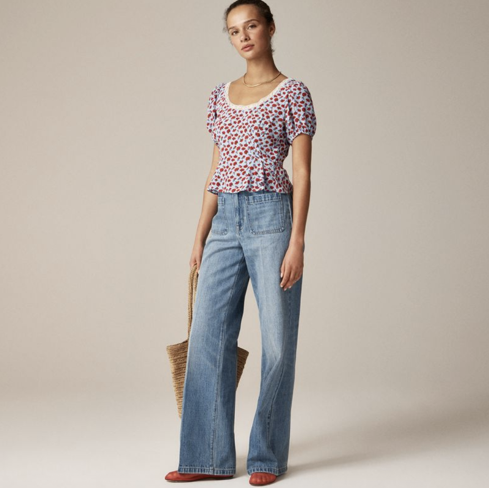 a model wears a floral jcrew shirt with wide leg jeans