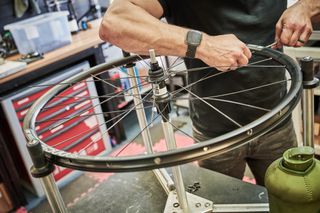 A man handbuilding a bicycle wheel