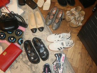 An assortment of shoes and bags on the floor