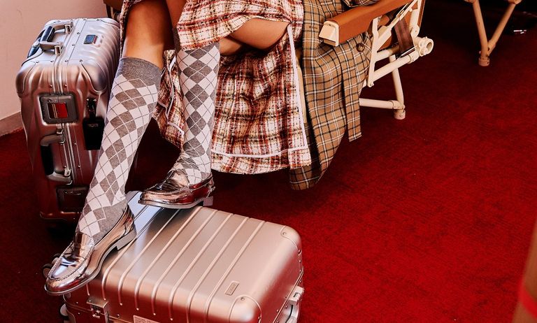 woman on a plane with suitcases