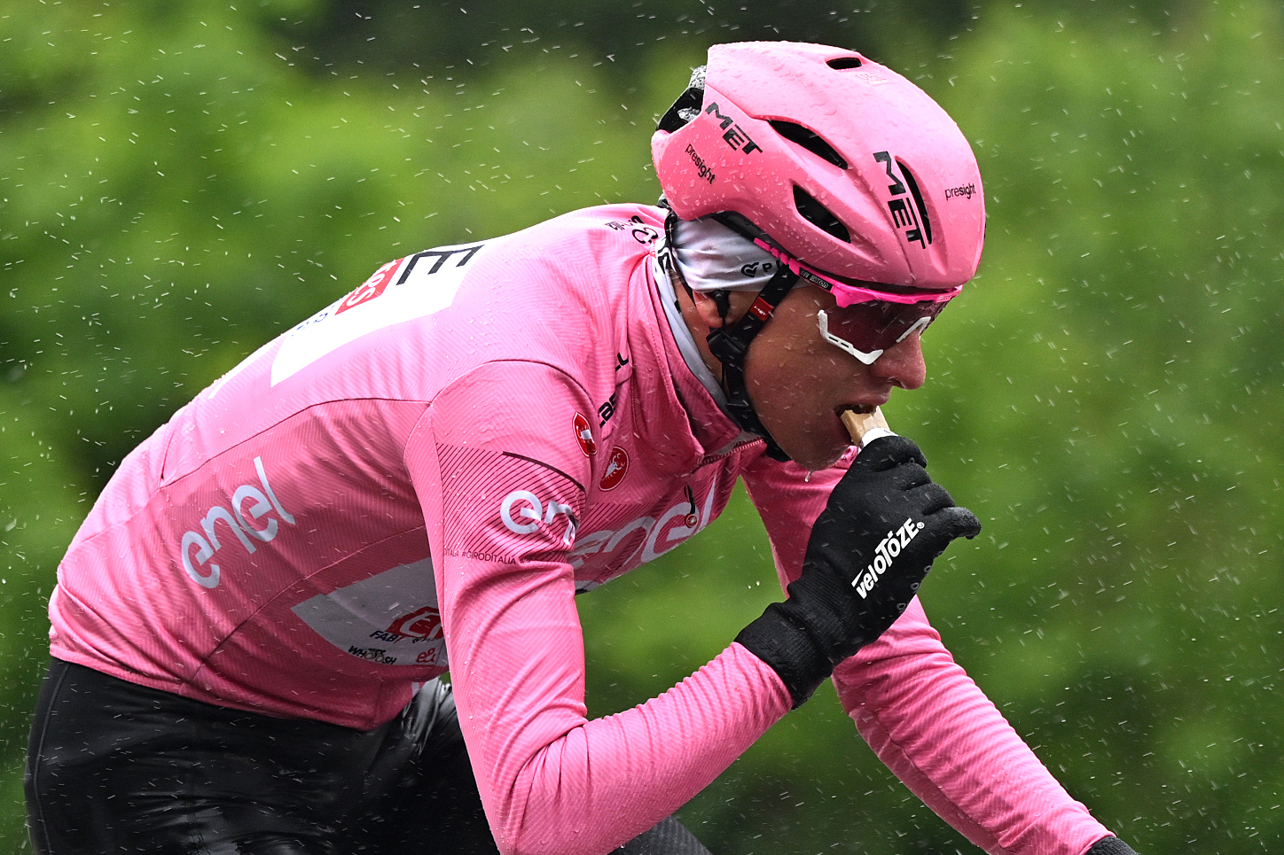 Tadej Pogačar eating a bar at the Tour of Italy