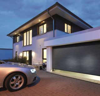 A garage with roller door attached to a modern home