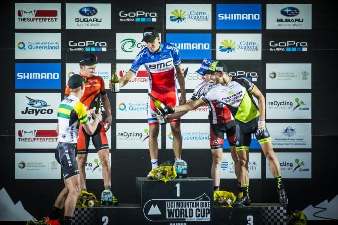 The Men's podium after a muddy round two