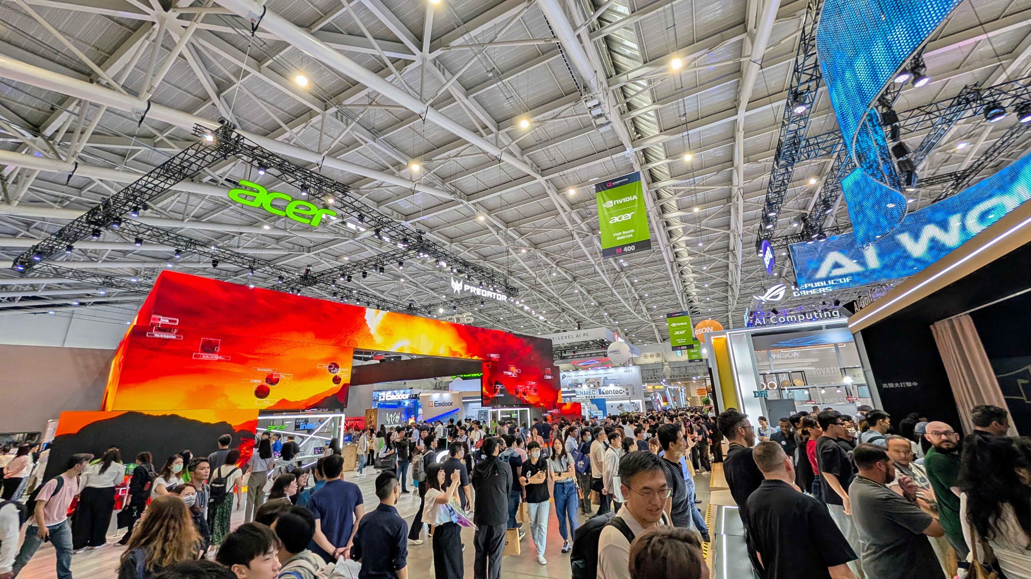 Wide angle show floor photo at Computex 2025 showing Acer booth with custom video screens