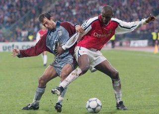 Arsenal's Patrick Vieira holds off a Bayern Munich player in a Champions League game in March 2001.