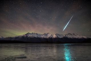 A gorgeous, green meteor flies toward the northern lights in this stunning image by astrophotographer Matthew Skinner. He captured the meteor over a mountain range near Palmer, Alaska just after midnight on Dec. 14, when the Geminid meteor shower was at its peak. To the left of the meteor, a lime-green aurora peeks out from the top of the mountain range.