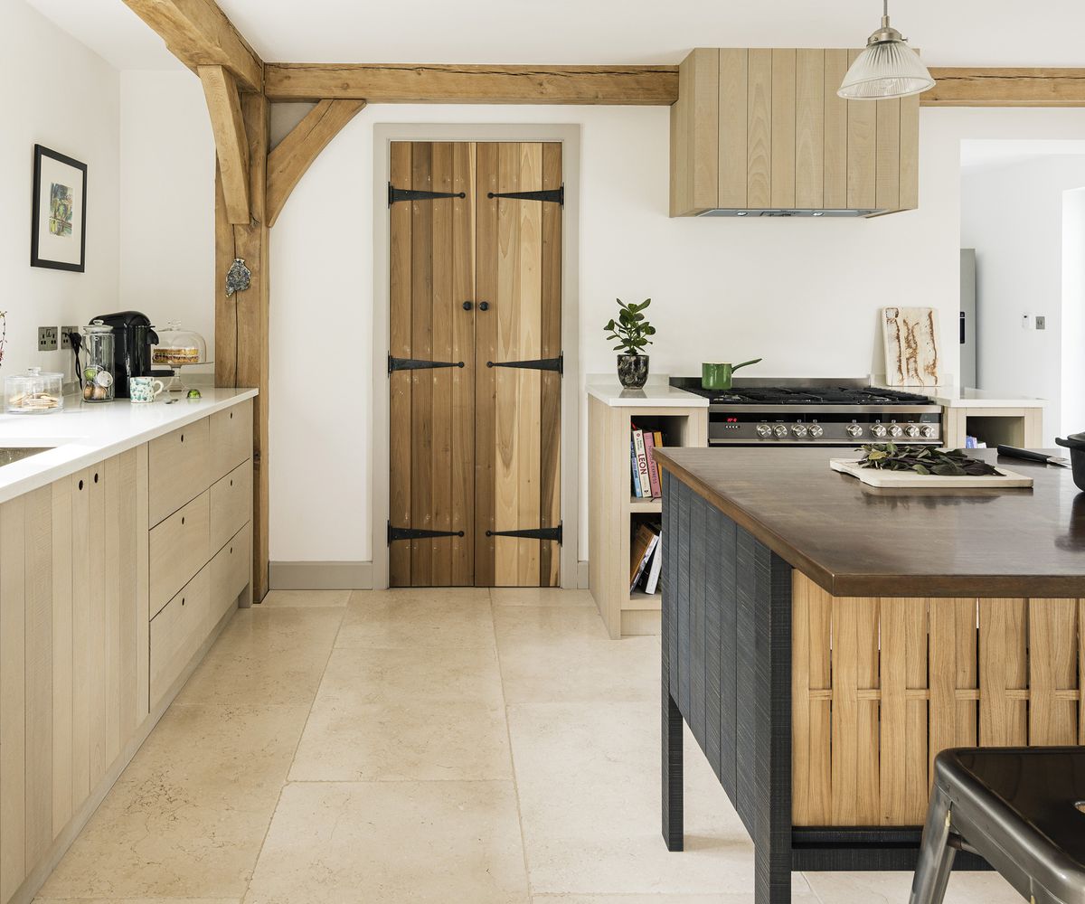 A neutral kitchen with wooden cabinets and freestanding central island