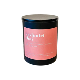 A Kashmiri chai-scented black candle with a pastel pink label