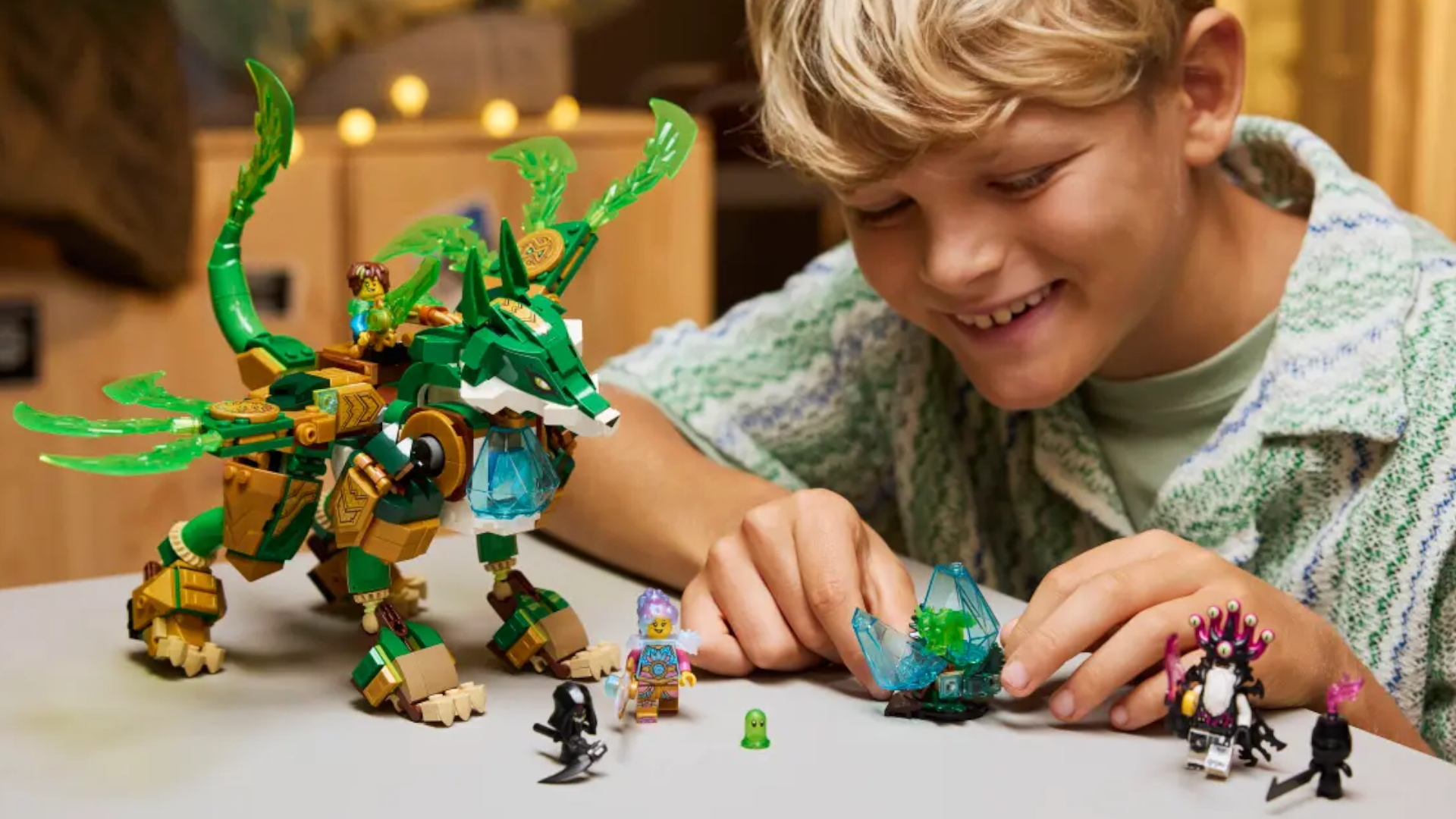 A child smiles while playing with a robot Lego fox and accessories