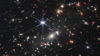 field of stars and galaxies against black background