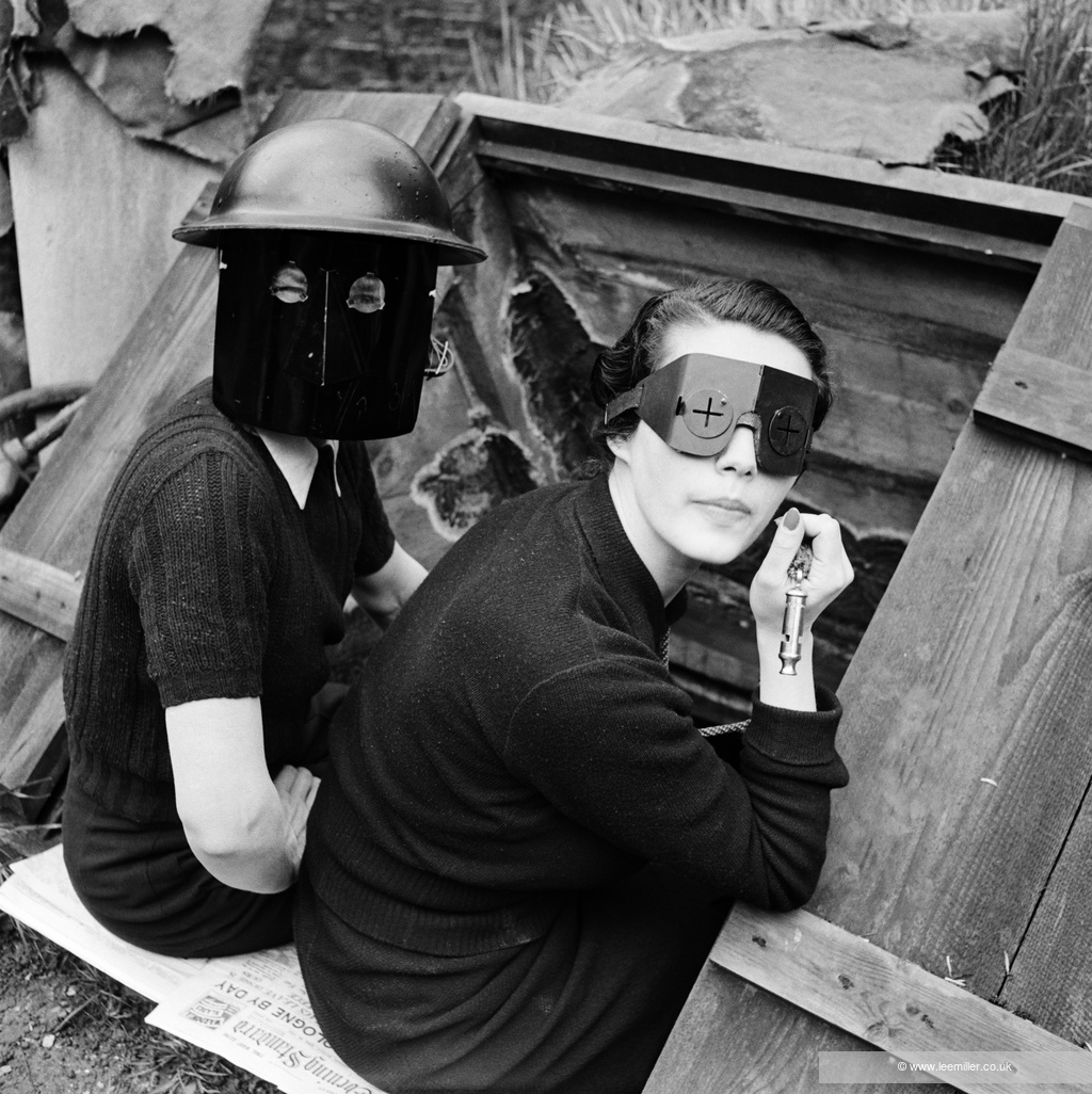 Lee Miller photograph of couple in Anderson shelter, with masks