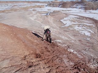 Crew 133 engineer Joseph Jessup navigates a steep hill near Utah's Mars Desert Research Station, Jan. 8, 2014.