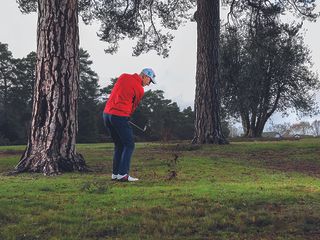 Golf Monthly Top 50 Coach Barney Puttick hitting a low shot to avoid tree branches