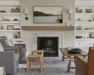 A neutrally toned living room with a large marbled fireplace and Samsung Frame TV