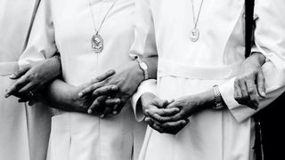 A group of nuns linking arms in solidarity.