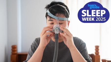 A man places a sleep apnea CPAP machine mask on his face, a Tom's Guide Sleep Week 2025 graphic (right)