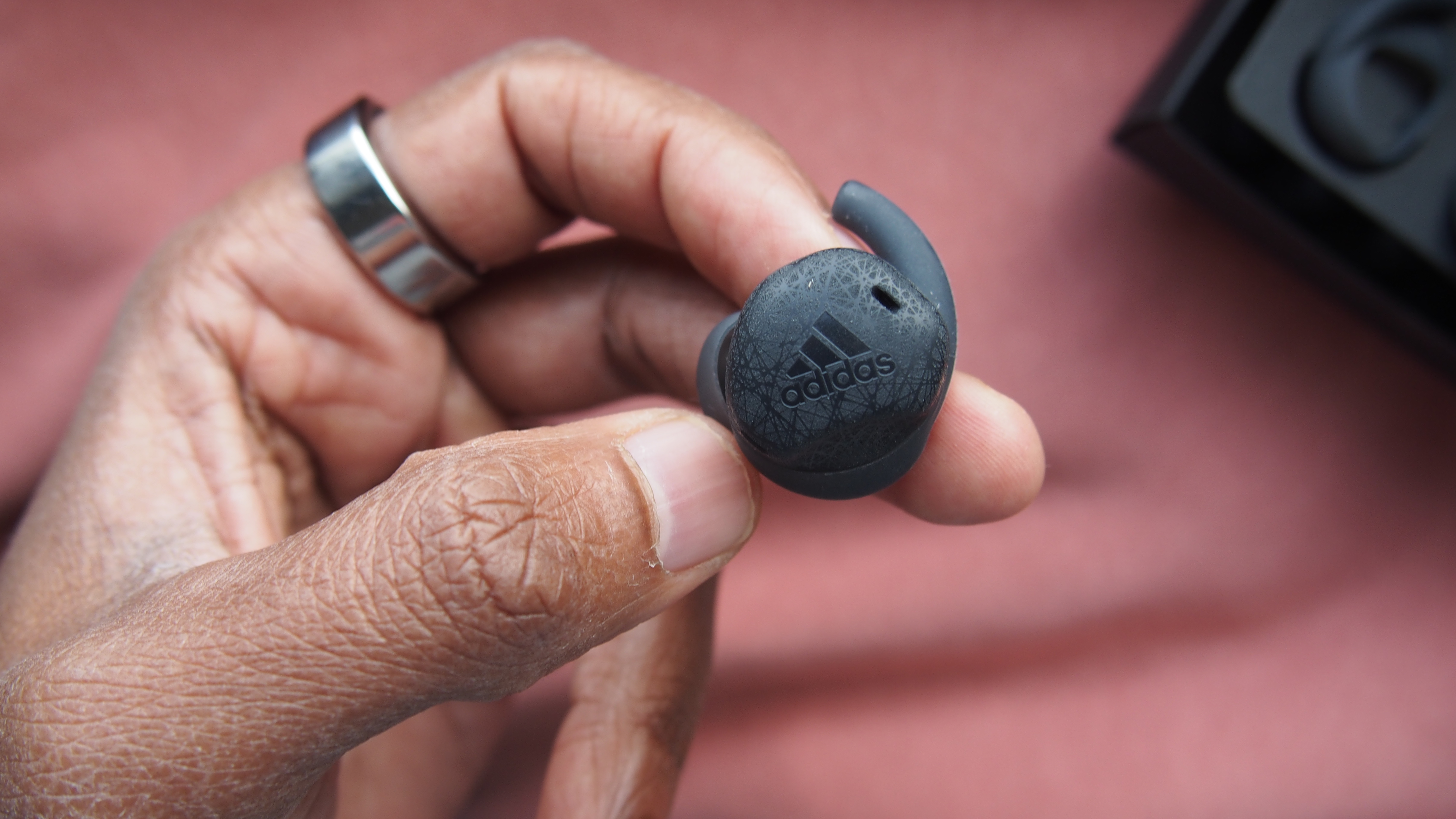 a closeup of the adidas fwd-02 sport earbuds