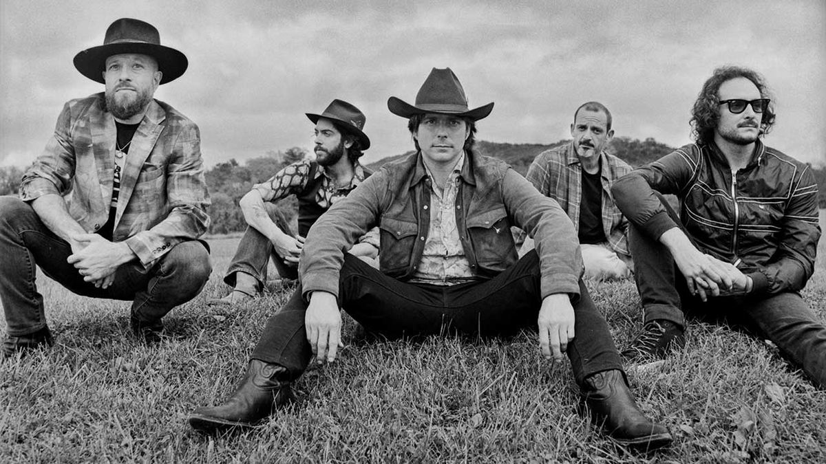 Lukas Nelson &amp; Promise of the Real sitting on grass