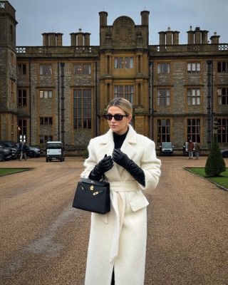 Woman white coat and long black leather gloves.