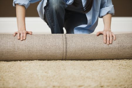 man rolling up carpet