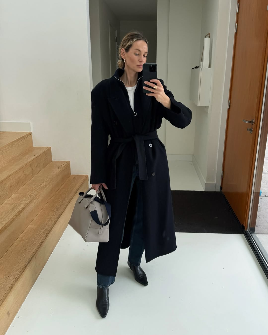 Anouk in almond-toe boots and a coat