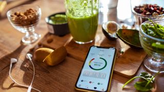 App tracking daily steps and calories on a breakfast table