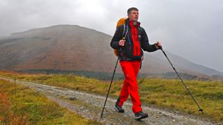 Man wearing Haglöfs LIM ZT Trek GTX PRO Jacket in misty mountains
