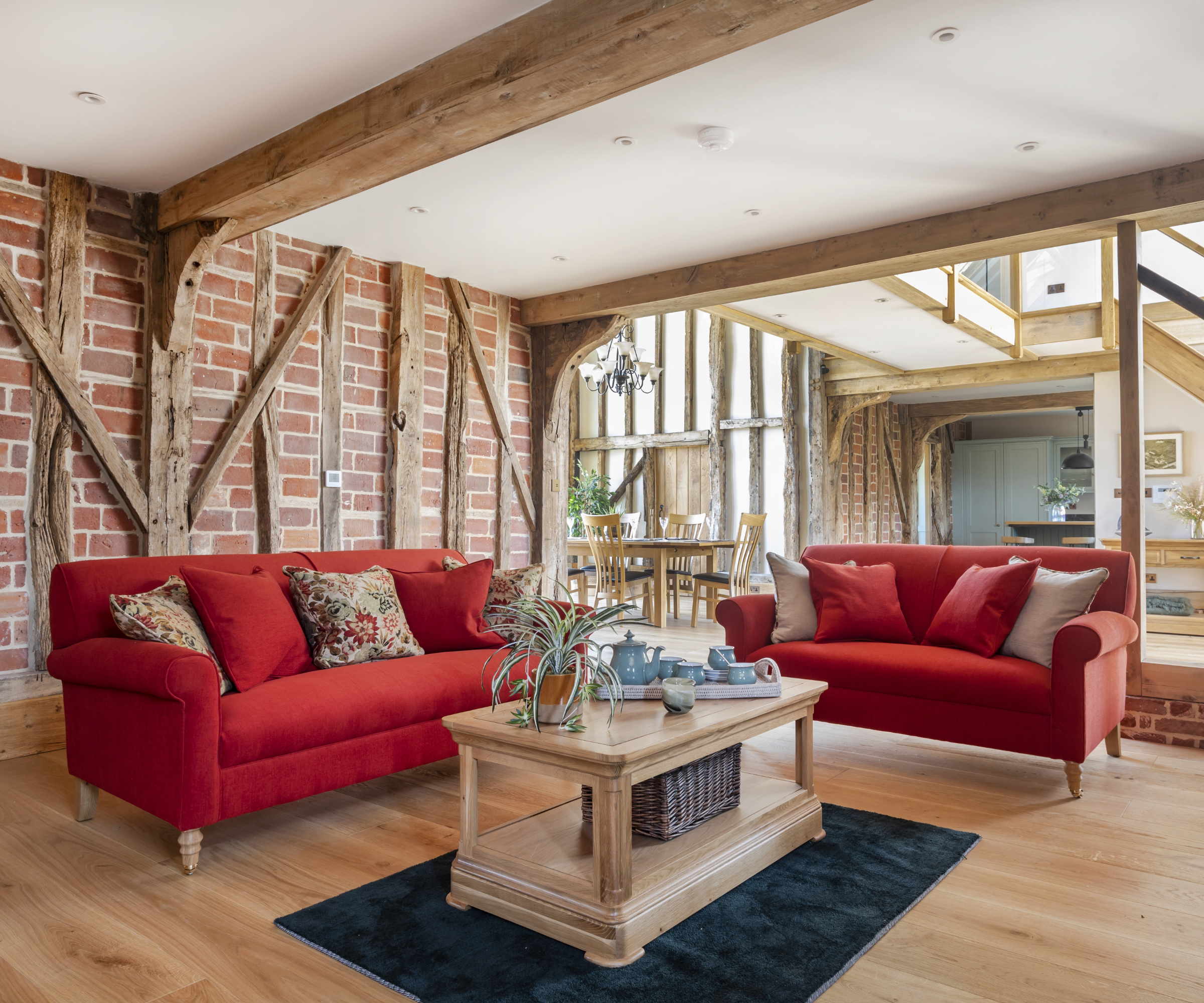 Living area in a barn conversion with spotlights on the ceiling