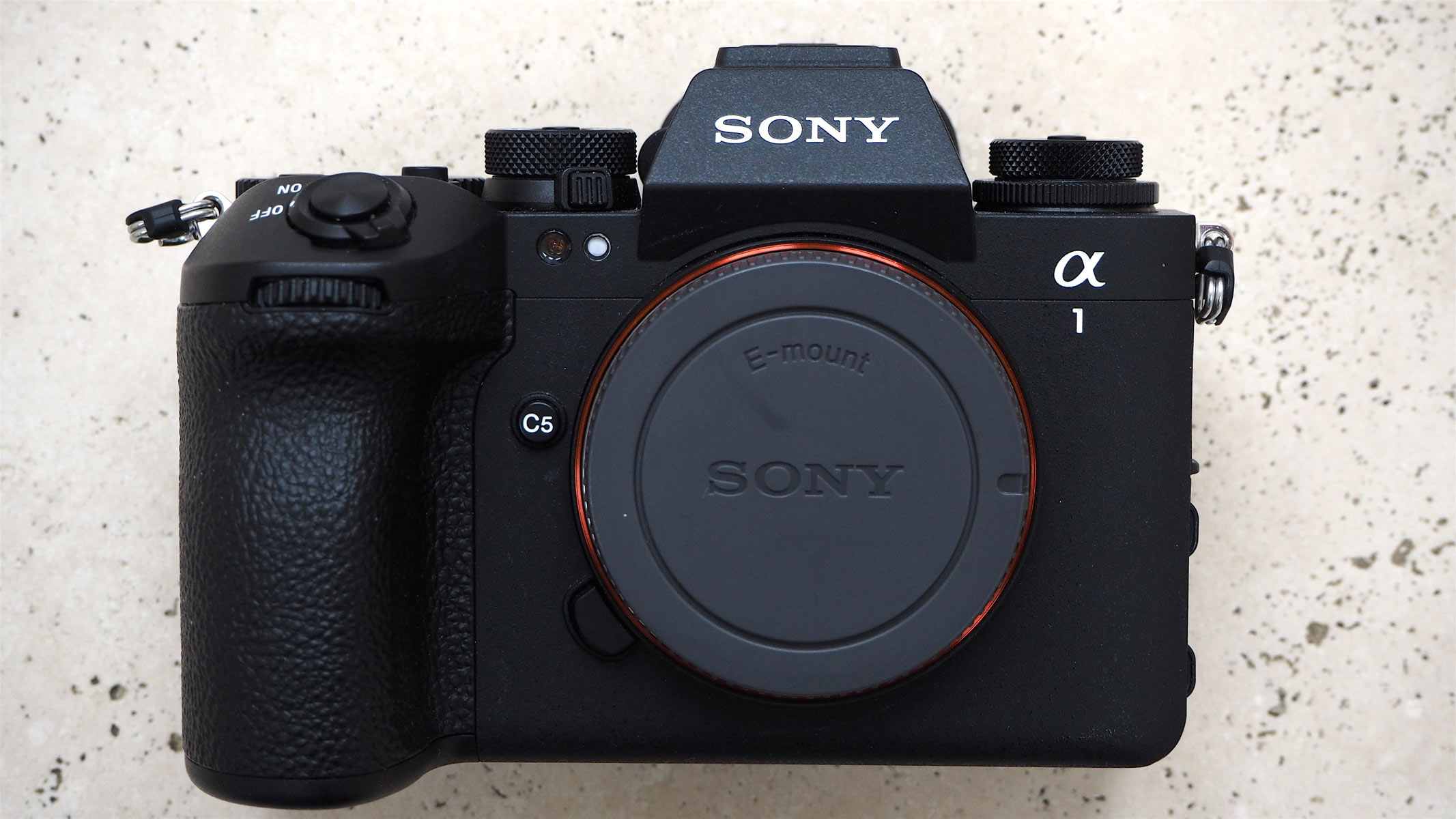A front view of Sony A1 II showing the body cap attached.