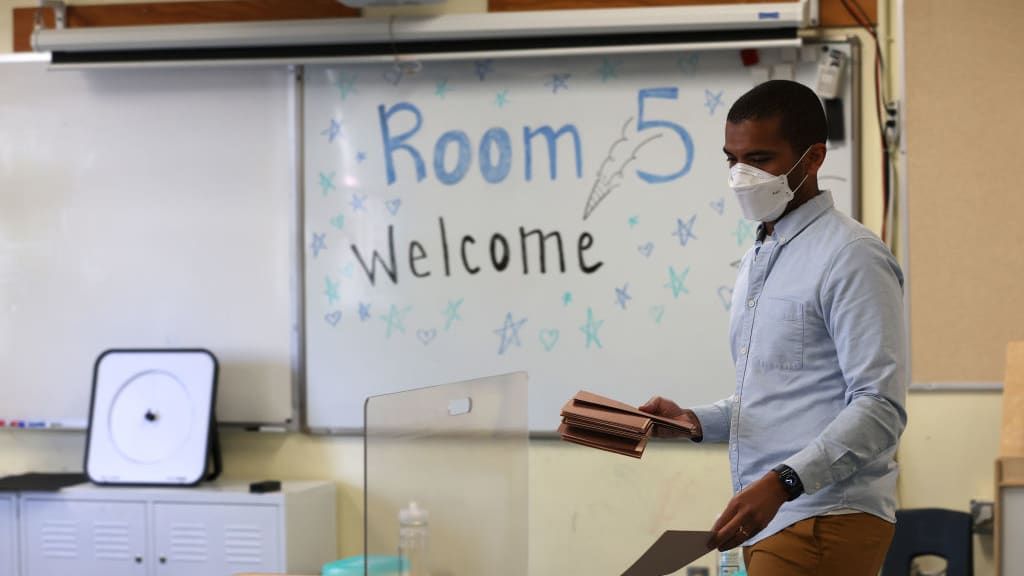 A teacher prepares his classroom.