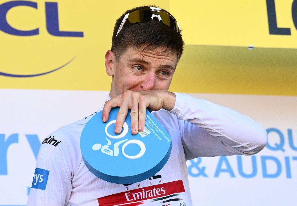 UAE Team Emirates teams Slovenian rider Tadej Pogacar with the best young riders white jersey reacts on the podium after the 20th stage of the 109th edition of the Tour de France cycling race 407 km individual time trial between LacapelleMarival and Rocamadour in southwestern France on July 23 2022 Photo by Marco BERTORELLO AFP Photo by MARCO BERTORELLOAFP via Getty Images