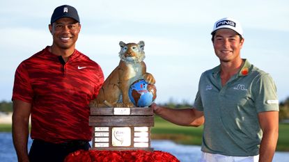Host Tiger Woods and 2021 Hero World Challenge winner Viktor Hovland pose with the trophy
