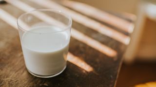 Glass of milk sitting on a wooden table