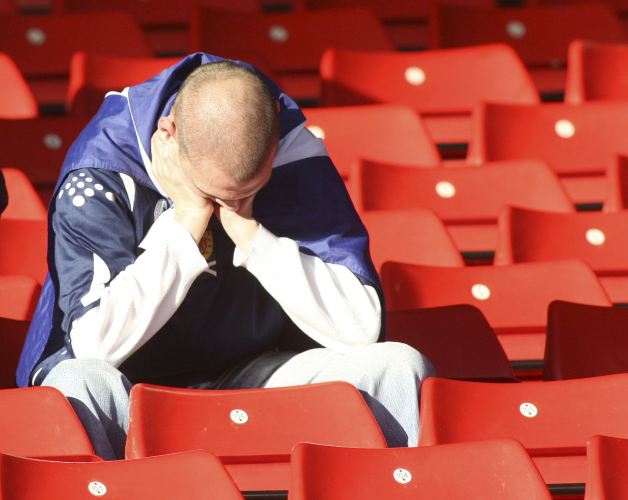 A Scotland fan holds his head in his hands after failing to beat Belarus