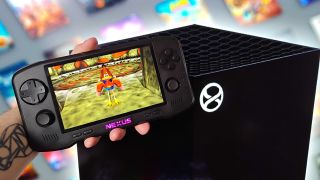 Hand holding Evercade Nexus next to a mockup of the next-gen Xbox Project Helix console with Banjo-Tooie gameplay on screen with Kazooie in trot mode.