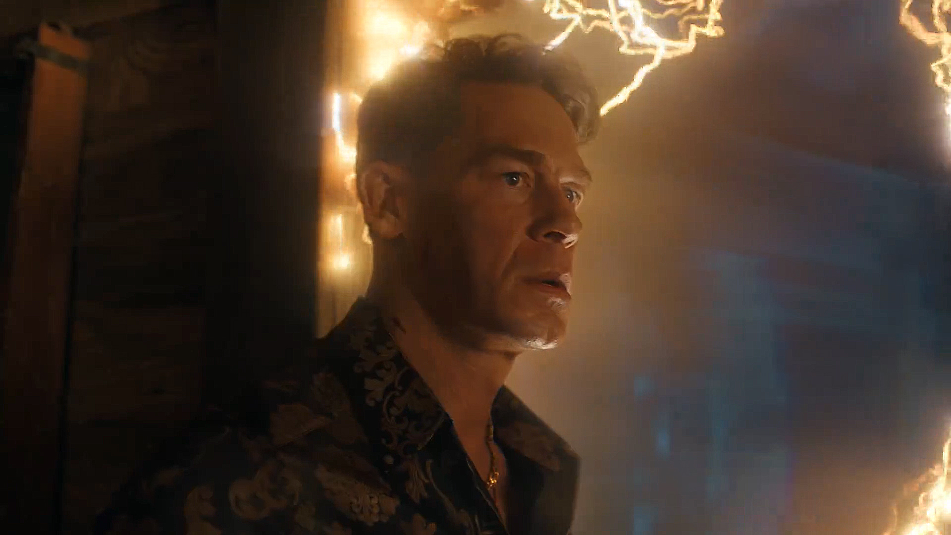 Chris Smith standing in a multiversal doorway in Peacemaker season 2 episode 4