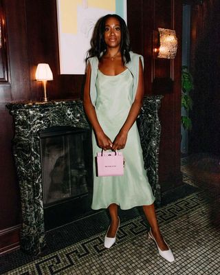 @chrissyford in a slip dress with a jumper and slingback heels