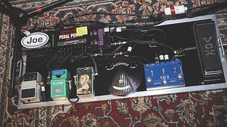 A well stocked pedalboard complete with power supply